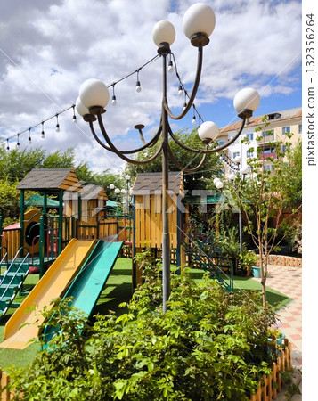 Children's playground with slides and wooden houses in the open air 132356264