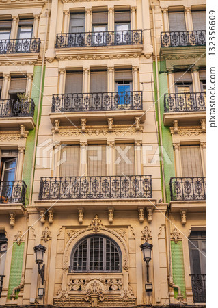 Art Nouveau building facade with wrought iron balconies and decorative stucco details in Alicante, Spain 132356609
