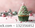 Festive cupcake decorated like a Christmas tree with pink ornaments and winter holiday ambiance 132356852
