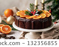 Chocolate cake decorated with orange slices and festive greenery for winter holiday celebration 132356855