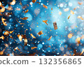 Colorful confetti falling against a blurred blue backdrop with copy space for holiday designs 132356865