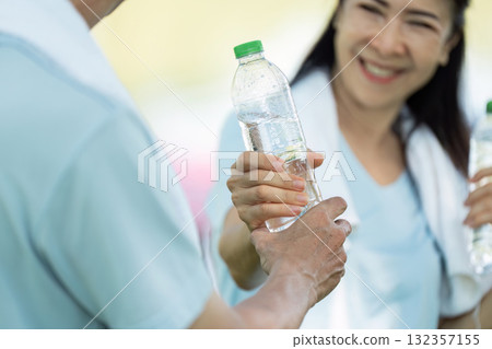 Wellness and Senior Hydration. Seniors enjoying water after a workout session. Wellness and Senior Hydration. Seniors enjoying water after a workout session. 132357155