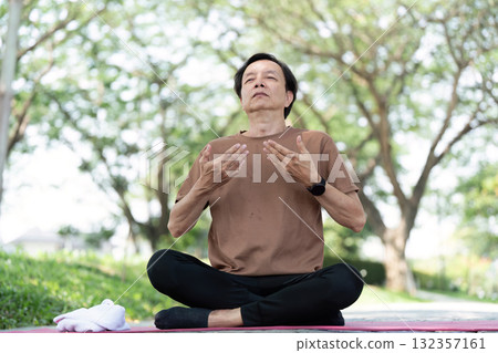 Wellness yoga meditation with senior man enjoying nature Wellness yoga meditation with senior man enjoying nature 132357161