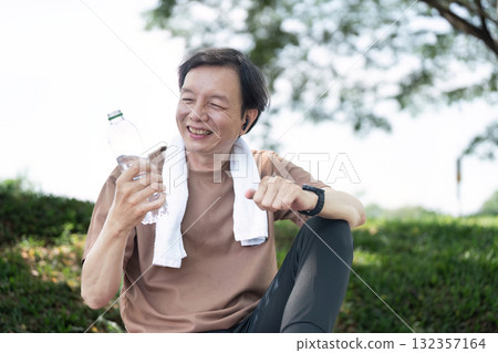 Wellness in Yoga: Senior man smiling while drinking water Wellness in Yoga: Senior man smiling while drinking water 132357164