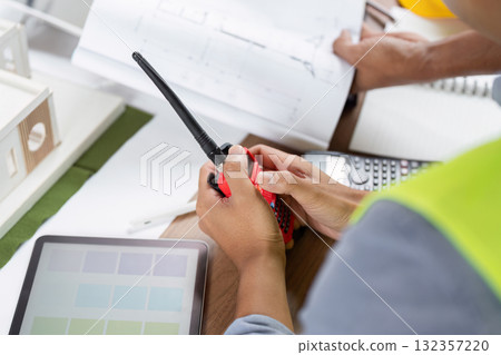 Green tech engineers coordinating wind energy project details Green tech engineers coordinating wind energy project details 132357220