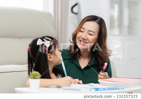 Back to School and Smiles. A mother and daughter share a joyful moment while learning together. 132357325
