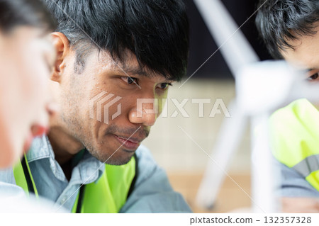 Green tech presentation with engineers analyzing sustainable projects 132357328