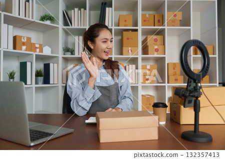Entrepreneurship and Customer Interaction. A woman interacts with her audience while promoting her online products. Entrepreneurship and Customer Interaction. A woman interacts with her audience while promoting her online products. 132357413