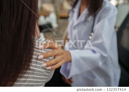 Emotional Support and Health Monitoring. A doctor provides comforting support to a patient during a medical consultation, fostering trust and care. Emotional Support and Health Monitoring. A doctor provides comforting support to a patient during a medical consultation, fostering trust and care. 132357414