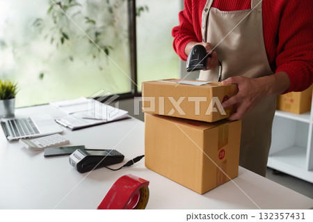 Small business owner packing products for shipping 132357431
