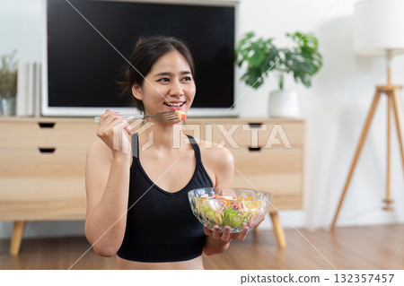 Wellness balance enjoying salad with joyful expression Wellness balance enjoying salad with joyful expression 132357457