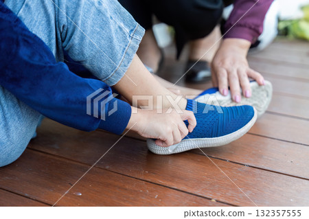 Back to School Preparation. A child getting help putting on new sneakers for the school year. 132357555