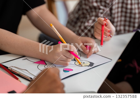 Artistic Expression and Collaboration. Hands of young learners creating art together. 132357588