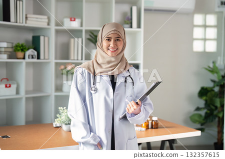 Healthcare Professional and Patient Care. A confident female doctor poses with a clipboard, ready to assist her patients. Healthcare Professional and Patient Care. A confident female doctor poses with a clipboard, ready to assist her patients. 132357615