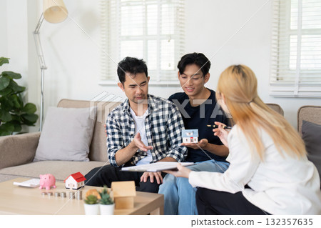 LGBT and Financial Planning. A gay couple discussing savings and investment options with a financial advisor, planning their future together. LGBT and Financial Planning. A gay couple discussing savings and investment options with a financial advisor, planning their future together. 132357635