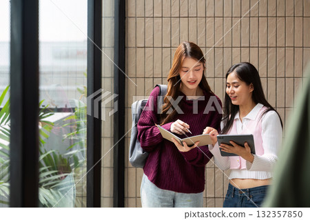 Study Collaboration and Engagement. Friends discussing their coursework while exploring resources together. Study Collaboration and Engagement. Friends discussing their coursework while exploring resources together. 132357850