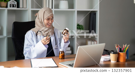 Telemedicine and Patient Interaction. A healthcare provider showcases medication options during a remote consultation with a patient. 132357901