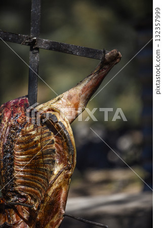 Lamb on the spit, cooked with the traditional Argentine method, La Pampa province, Patagonia, Argentina. 132357999
