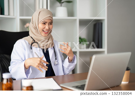 Virtual Healthcare and Patient Engagement. A friendly healthcare provider conducts an online consultation with a patient. 132358004