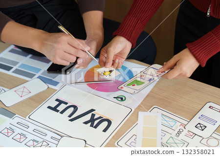 Design Exploration and Iteration. UX UI designers analyzing design elements and color palettes for an innovative project. Design Exploration and Iteration. UX UI designers analyzing design elements and color palettes for an innovative project. 132358021