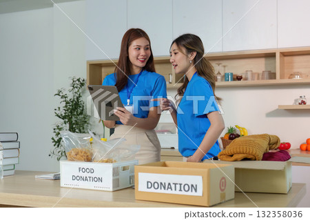 Volunteers Collaborating on Donations. Engaging in community support and organization. Volunteers Collaborating on Donations. Engaging in community support and organization. 132358036