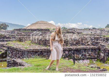 Female tourist standing in front of Teotihuacan pyramids in Mexico, enjoying sightseeing, adventure, and cultural heritage. Travel, tourism, and exploration concept Female tourist standing in front of Teotihuacan pyramids in Mexico, enjoying sightseeing, adventure, and cultural heritage. Travel, tourism, and exploration concept 132358832