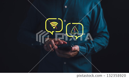 Person holding a smartphone with no Wi-Fi and warning alert icons, representing connection failure, network error, internet outage issue, network failure, offline mode and technology disruption. 132358920
