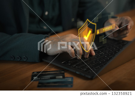 Hand typing on laptop with security shield and password login interface, representing online payment protection, business online, cybersecurity, digital identity safety and secure transactions. 132358921