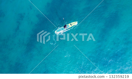 People practicing paddleboarding on the sea 132359219