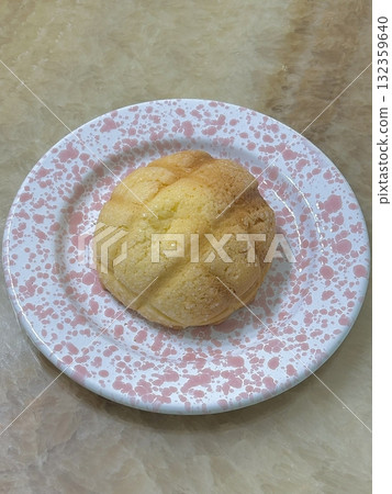 Melon Ppang, a fluffy Korean bread shaped like a melon with a crisp, sugary top layer. Popular for its sweet flavor and unique look, it's a delightful treat perfect for snacks or desserts. 132359640