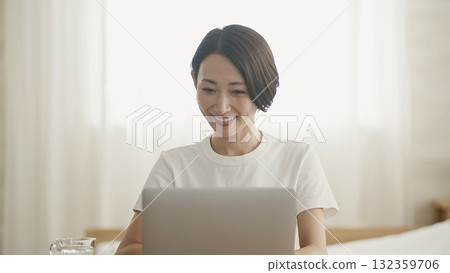 A woman who plays a personal computer A woman who plays a personal computer 132359706