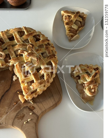 Homemade Apple Pie with fresh apples on white kitchen table, top view, flat lay. Thanksgiving traditional dessert, Thanksgiving tart preparation, autumn bakery. Crispy weather sweets. Recipe 132359778