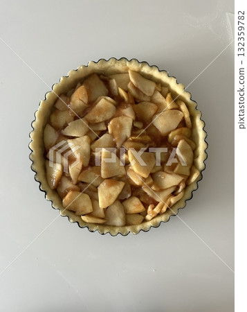 Homemade Apple Pie with fresh apples on white kitchen table, top view, flat lay. Thanksgiving traditional dessert, Thanksgiving tart preparation, autumn bakery. Crispy weather sweets. Recipe 132359782