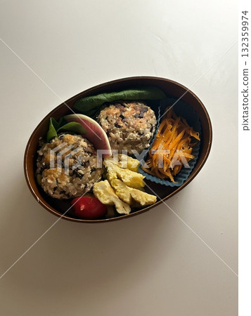 A traditional Korean dosirak, beautifully arranged with rice, assorted banchan, and savory proteins. Balanced and visually inviting, its a portable meal packed with vibrant flavors. 132359974