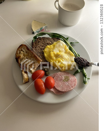 A delightful brunch spread featuring a mix of savory and sweet bites. perfectly toasted bread, fresh fruits, soft scrambled eggs, and a refreshing drink to brighten your late morning. A delightful brunch spread featuring a mix of savory and sweet bites. perfectly toasted bread, fresh fruits, soft scrambled eggs, and a refreshing drink to brighten your late morning. 132360028