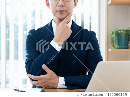 Businessman worried while looking at a computer 132360119