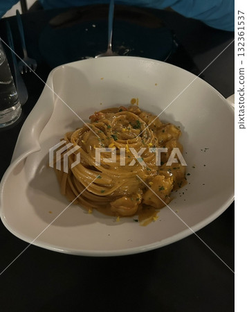 Creamy and rich spaghetti coated in a luscious white sauce, offering a smooth and savory flavor perfect for a comforting and satisfying meal. Creamy and rich spaghetti coated in a luscious white sauce, offering a smooth and savory flavor perfect for a comforting and satisfying meal. 132361537