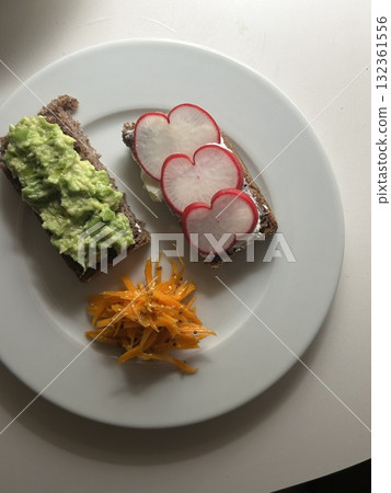 A delightful brunch spread featuring a mix of savory and sweet bites. perfectly toasted bread, fresh fruits, soft scrambled eggs, and a refreshing drink to brighten your late morning. 132361556