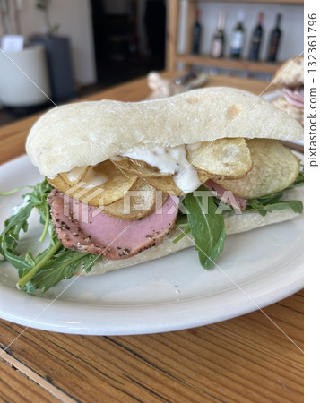 Delicious sandwich filled with fresh ingredients like crisp vegetables, tender meats, and savory spreads, all between two slices of soft bread. Perfect for a quick and satisfying meal. 132361796