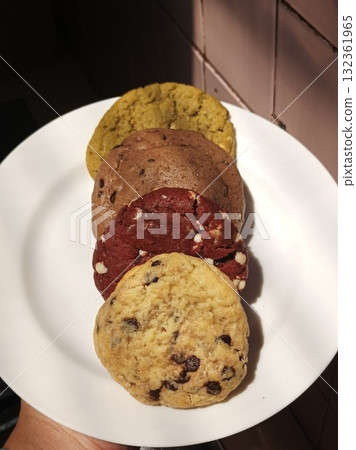 Freshly baked cookies with a golden-brown finish and chocolate chips. Perfectly crisp on the edges with a soft center, offering a delicious, comforting treat for any occasion. 132361965