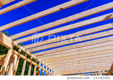 Wooden beams are being installed for rafters beams roofing new building Wooden beams are being installed for rafters beams roofing new building 132361982