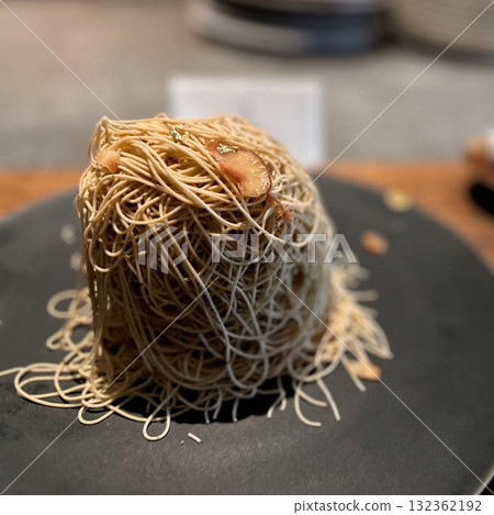 Refreshing bingsu, a Korean shaved ice dessert topped with sweet ingredients like red beans, fruits, and condensed milk. A perfect treat to cool down on hot days. 132362192
