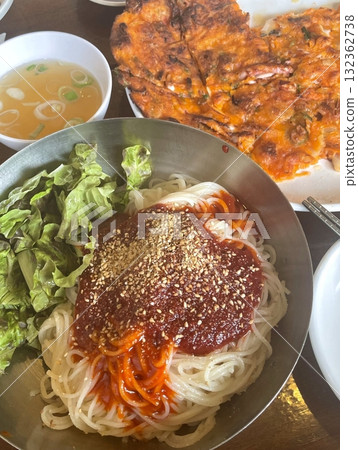 Authentic Pyongyang naengmyeon with chewy buckwheat noodles in cold, clear broth, offering a refreshing and delicate flavor. Perfect for traditional Korean cuisine menus and summer dishes. 132362738