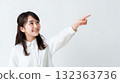 A girl pointing diagonally upwards 132363736