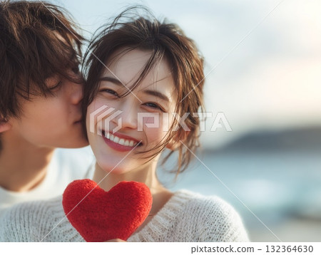 Man and woman kissing their lover on the cheek, smile and heart gift, image of love 132364630