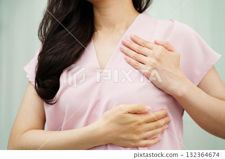 Asian woman self touching check lump or Breast cancer, Breast Self Exam. 132364674