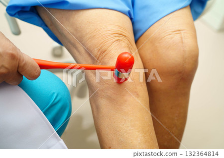 Asian doctor knock on knee reflex nerve for check and treatment senior patient in hospital. Asian doctor knock on knee reflex nerve for check and treatment senior patient in hospital. 132364814