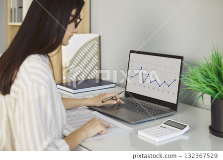 Focused Businesswoman Doing Accounting In Office Focused Businesswoman Doing Accounting In Office 132367529