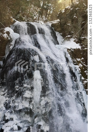 Bansho Falls in Nagano Prefecture freezes over during the harsh winter, creating a bleak expanse. 132368325