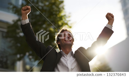 entrepreneur celebrating business success outdoors 132370843